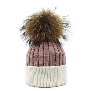Close-up of dual-color rib knit texture and large fluffy pom-pom on the beanie