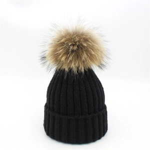 Classic black knitted wool hat for women with a large brown faux fur pom pom detail