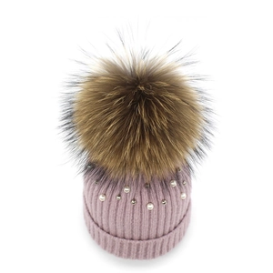 Pink knit pearl beanie with brown faux fur pom pom and wide ribbed fold cuff for winter