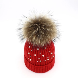 Red knit beanie for women with large real fur pompom and delicate pearl embellishments