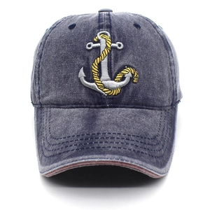 Close-up of anchor embroidery on washed denim baseball cap with reinforced stitching