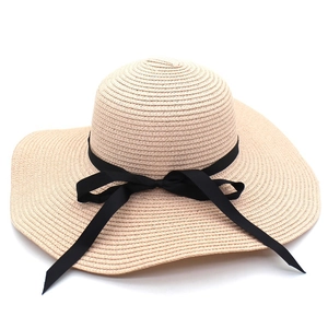 Classic beige wide brim straw hat with elegant black ribbon bow for summer sun protection