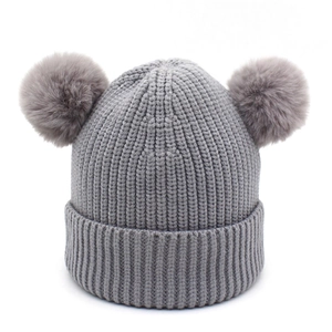 Detail of grey ribbed knit winter hat for kids with two cute faux fur pom-poms on top