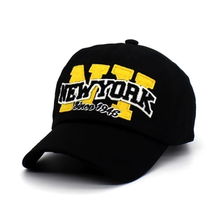 Close-up of yellow NY applique and New York 3D embroidery on black twill baseball cap