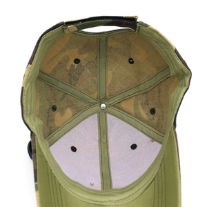 Detail view of camouflage baseball cap showing inner stitching and mesh reinforcement