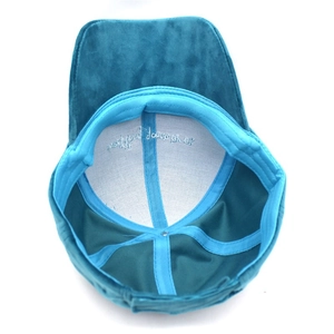 Detail of the blue velvet baseball cap interior with embroidery and reinforced seams