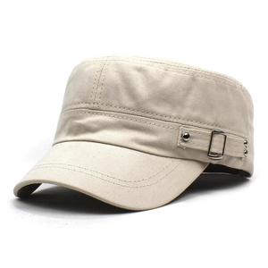 Detail of cotton cadet hat with metal buckles and side strap on beige canvas fabric