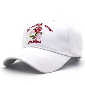 Detailed embroidery of pink roses and English text on a white cotton baseball cap