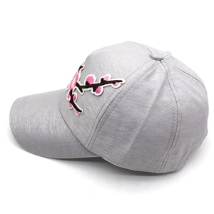 Grey baseball cap featuring pink flower embroidery on a textured polyester blend fabric