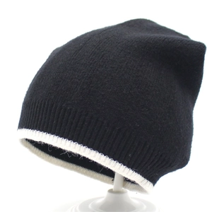 Women's warm knitted beanie hat in black and white contrast design for winter protection