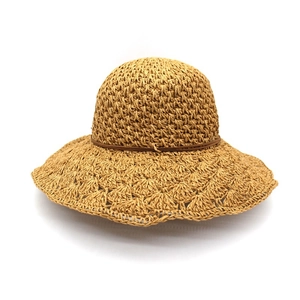 Wide brim raffia sun hat for women with a simple brown cord, ideal for summer beach holidays