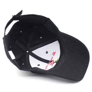 Internal view of black baseball cap with rose embroidery and adjustable metal buckle