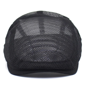 Detailed view of black mesh beret showing breathable honeycomb texture and flat brim edge