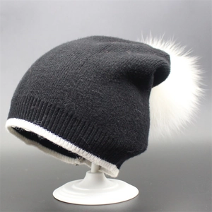 Classic black knitted beanie with a large white faux fur pompom and ribbed cuff detail