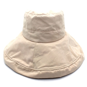 Detail view of the beige sun hat showing reinforced stitching on the wide brim