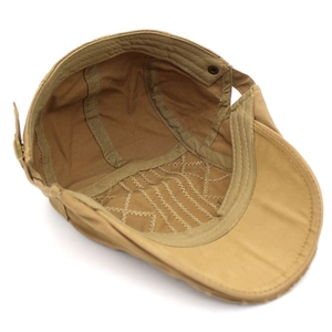 Internal structure of a khaki cotton newsboy cap with stitching and sweatband details