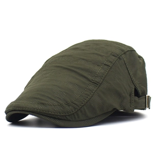 Detail view of military green newsboy cap with polka dot texture and metal side buckle