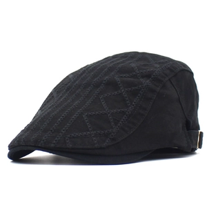 Detail view of cotton flat cap featuring geometric embroidery and metal side adjustment buckle