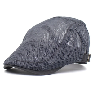 Close-up of dark grey mesh fabric and adjustable side buckle on breathable beret cap