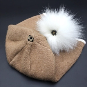 Camel knit beanie with white faux fur pompom and metal snap button closure