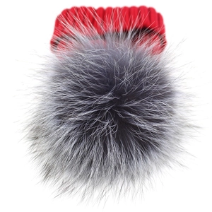 Winter warm knitted red hat featuring a fluffy oversized silver fox fur pom pom top