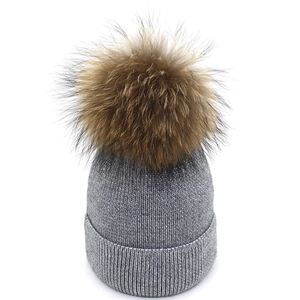 Winter silver grey knit beanie for women with large fluffy faux fur pompom detail