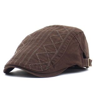 Detail view of brown cotton duckbill cap with geometric embroidery and metal buckle
