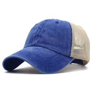 Detail of blue denim baseball cap with breathable beige mesh and vintage washed finish