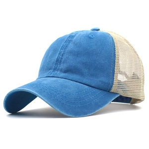 Detail of vintage denim blue cotton front and beige mesh back of trucker baseball cap