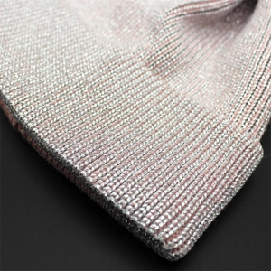 Close-up of pink knit hat with silver metallic threads and rib-knit texture detail