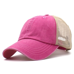 Detail view of pink washed cotton trucker hat with beige mesh back and contrast stitching