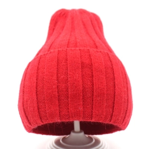Detailed close-up of bright red ribbed knit winter hat texture with soft wool-like finish