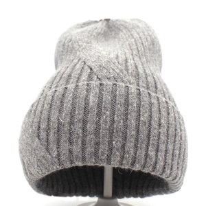 Detail of grey ribbed knit beanie showing thick wool texture and warm folded cuff design