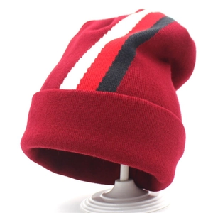 Deep red knitted beanie with black and white stripes and a stylish wide fold-over cuff