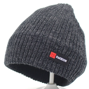 Dark grey knitted beanie with ribbed texture and Fashion label on white background