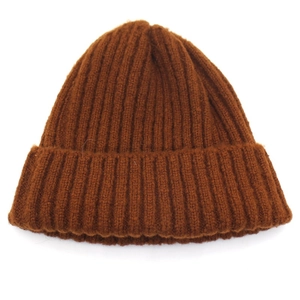 Close-up detail of dark brown ribbed knit beanie with wide folded cuff for winter