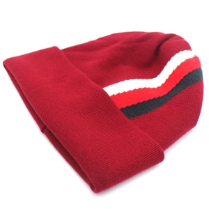 Detailed knit texture of burgundy beanie featuring decorative white red and black stripes
