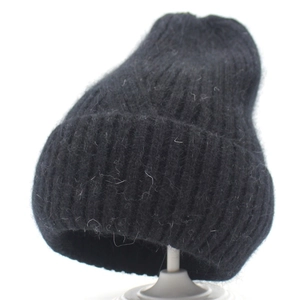 Fuzzy black knit beanie with mohair texture and wide folded cuff for winter warmth