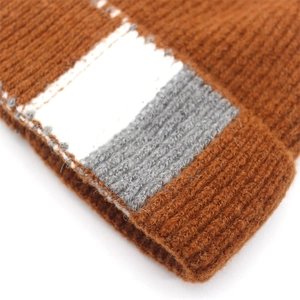 Detail of thick caramel wool blend ribbed knit texture with color-block stitching design