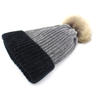 Detail of chenille knit beanie showing thick ribbed texture and faux fur pompom decoration