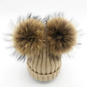 Gorro de punto beige con dos grandes pompones marrones para mujer en invierno