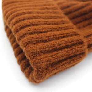 Caramel brown knit beanie with vertical ribbed texture and folded brim for winter warmth