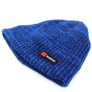 Detail of dark blue rib-knit beanie showing the thick texture and fashion label