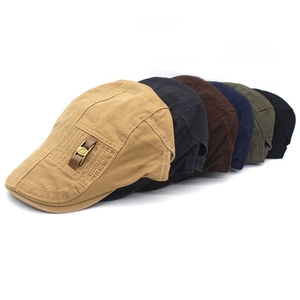 Detailed view of assorted retro cotton beret hats in khaki, navy, and black with side buckle