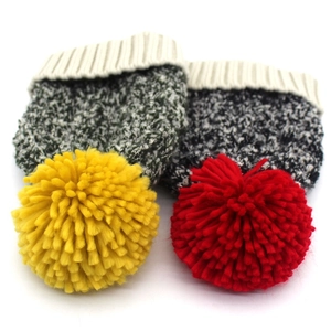 Thick knitted beanie with large faux fur pompom in vibrant red and yellow colors