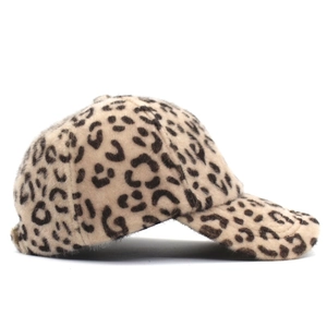 Detailed side view of leopard print plush baseball cap with soft faux fur fabric texture