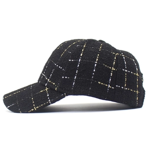 Détail d'une casquette de baseball en tweed noir avec fils métalliques or et argent