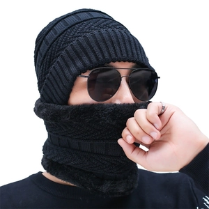Detail of black cable knit beanie and neck warmer set with thick faux fleece lining