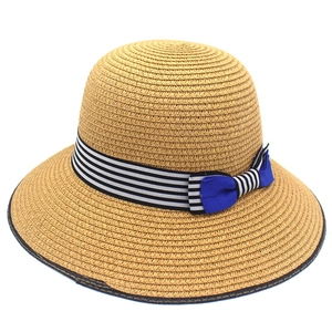Women's summer straw sun hat with striped ribbon and blue bow for beach outings