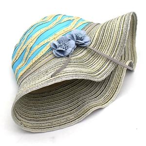 Women's blue and beige striped woven sun hat with decorative fabric flowers for summer